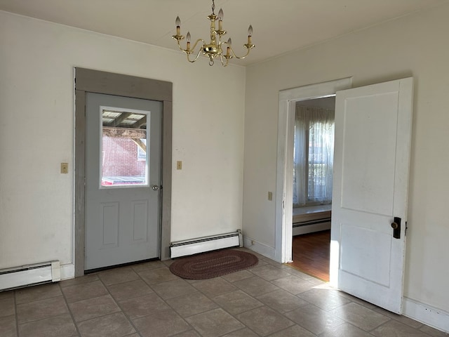 foyer entrance featuring a wealth of natural light, an inviting chandelier, and a baseboard heating unit