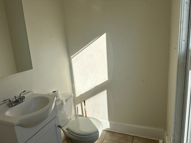 bathroom featuring tile patterned flooring, vanity, and toilet