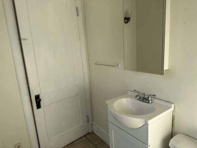 bathroom featuring tile patterned floors, vanity, and toilet