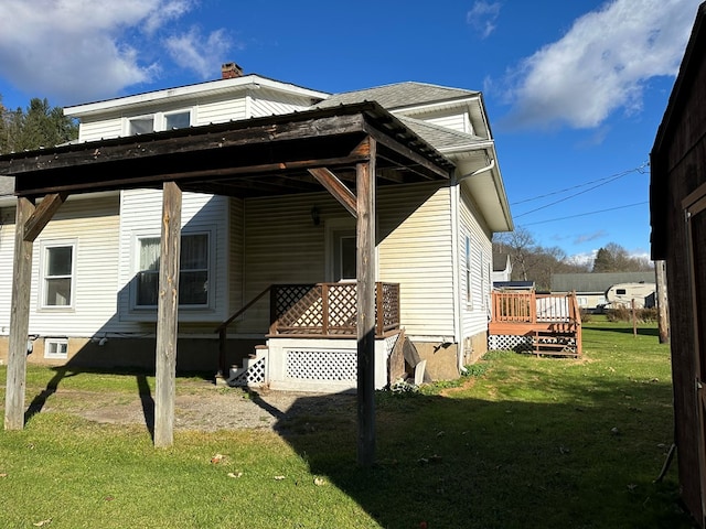 view of side of home featuring a lawn and a wooden deck