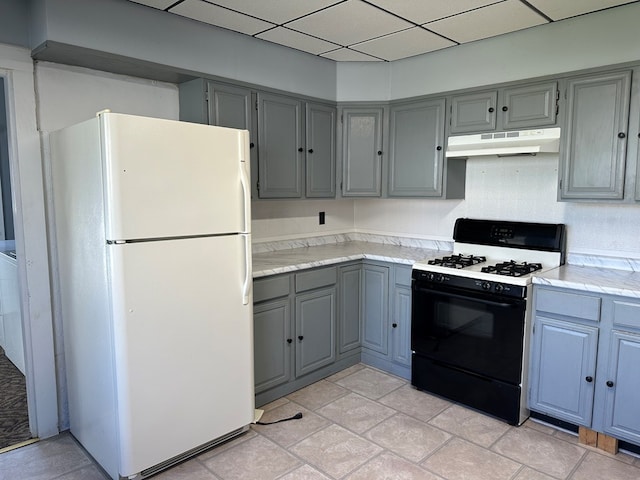 30 Turner St, Austin, PA 16720 - kitchen featuring freestanding refrigerator, black gas stove, gray cabinets, under cabinet range hood, and light countertops