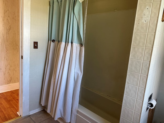 bathroom featuring tile patterned floors and shower / bath combo with shower curtain