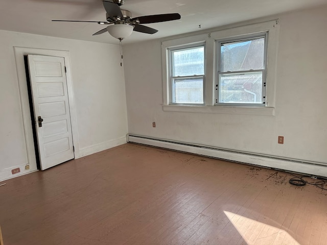 empty room featuring baseboard heating, ceiling fan, and wood-type flooring