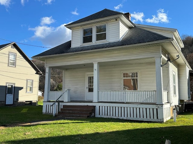30 Turner St, Austin, PA 16720 - view of front of home with covered porch, roof with shingles, a front lawn, and a chimney