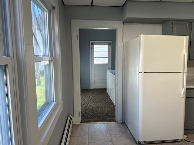 kitchen featuring gray cabinets, white fridge, and a baseboard radiator