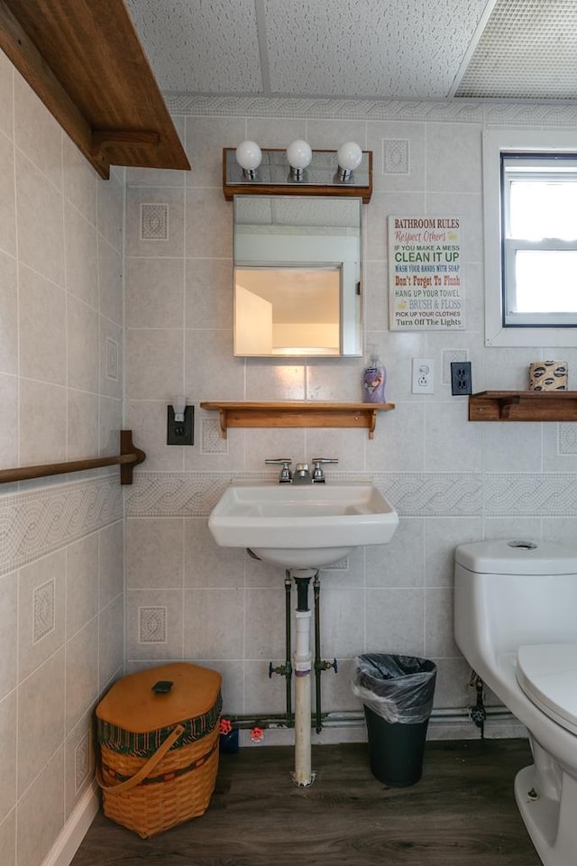 77 Pine Creek Village Rd, Gaines, PA 16921 - half bathroom featuring wood finished floors, toilet, and tile walls