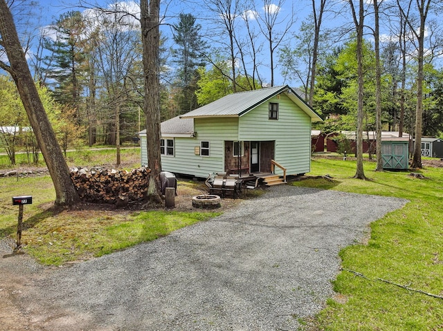 77 Pine Creek Village Rd, Gaines, PA 16921 - back of property with an outbuilding and a yard