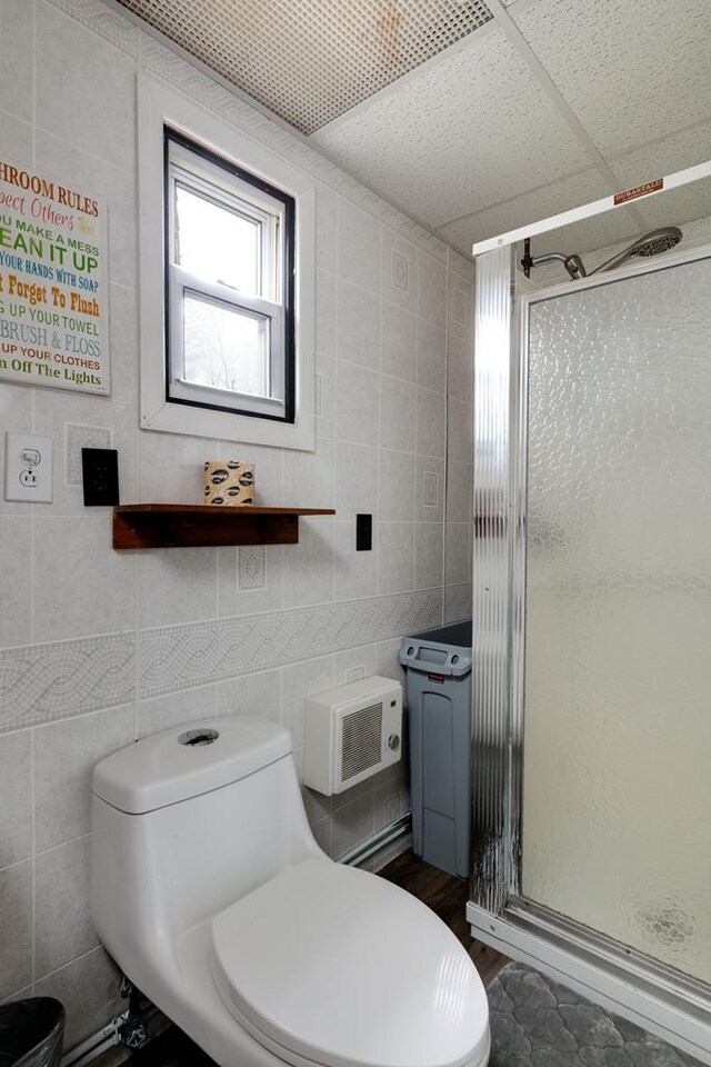 77 Pine Creek Village Rd, Gaines, PA 16921 - bathroom featuring toilet, tile walls, wood finished floors, and a stall shower