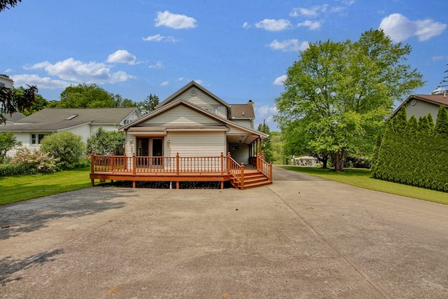 67 W Ave, Wellsboro, PA 16901 - view of front facade featuring a front yard, a wooden deck, and a chimney