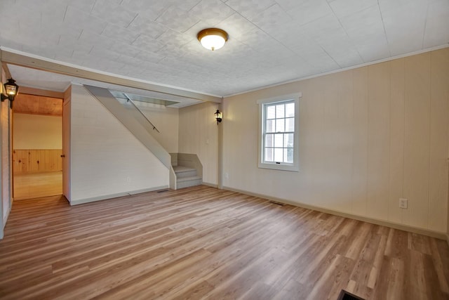 interior space with hardwood / wood-style flooring and crown molding