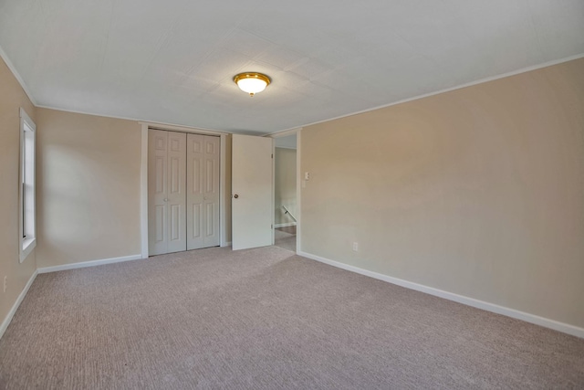 unfurnished bedroom with carpet flooring and a closet