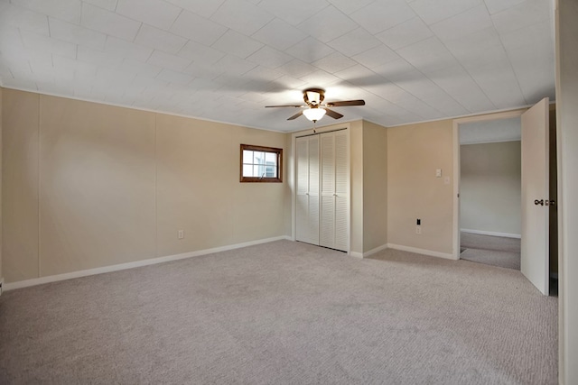 unfurnished bedroom with ceiling fan, light carpet, and a closet
