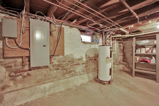 basement featuring water heater and electric panel
