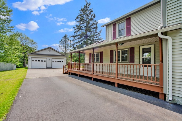 67 W Ave, Wellsboro, PA 16901 - view of front of home with a detached garage, a porch, an outbuilding, and a front yard