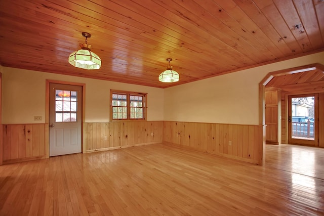 unfurnished room with a wealth of natural light, wooden ceiling, and light hardwood / wood-style flooring