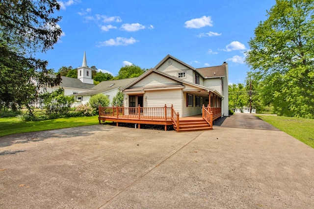 67 W Ave, Wellsboro, PA 16901 - view of front of home featuring a chimney, a wooden deck, and a front yard