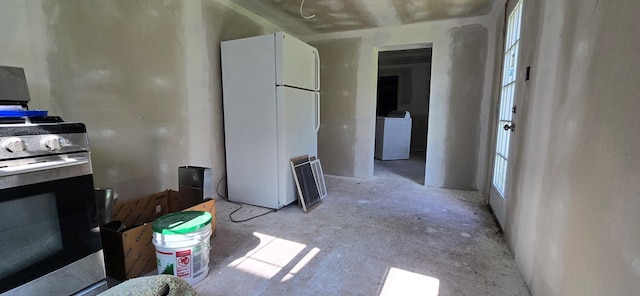 kitchen with gas stove, washer / clothes dryer, white cabinetry, and white refrigerator