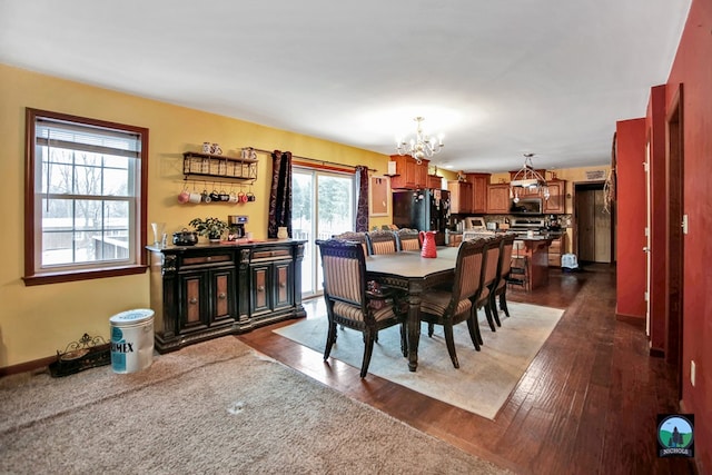 dining room featuring dark wood-type flooring and a notable chandelier