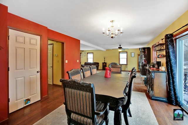 dining space featuring ceiling fan with notable chandelier and wood-type flooring