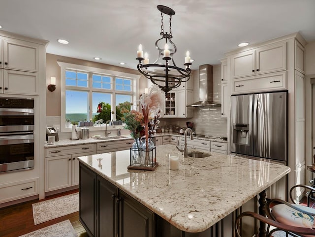4535 Covered Bridge Rd, Ulster, PA 18850 - kitchen with wall chimney exhaust hood, a sink, stainless steel appliances, a chandelier, and recessed lighting