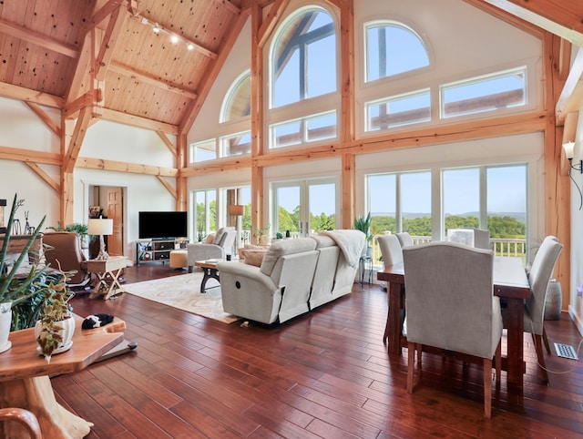 4535 Covered Bridge Rd, Ulster, PA 18850 - living area featuring high vaulted ceiling, wood ceiling with exposed beams, plenty of natural light, and dark wood-style floors