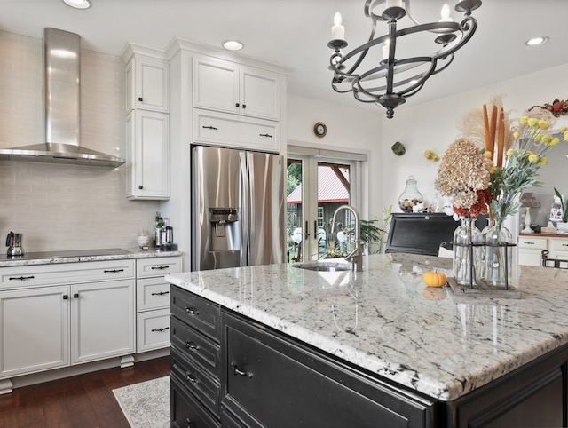 4535 Covered Bridge Rd, Ulster, PA 18850 - kitchen with stainless steel fridge, wall chimney exhaust hood, a chandelier, a sink, and dark cabinetry