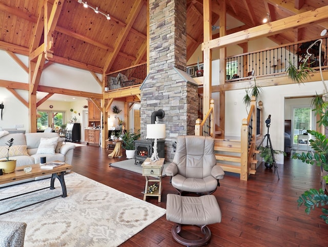 4535 Covered Bridge Rd, Ulster, PA 18850 - living room featuring high vaulted ceiling, a wood stove, wood ceiling with exposed beams, stairs, and rail lighting