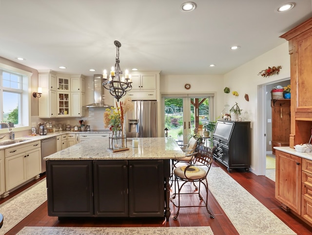 4535 Covered Bridge Rd, Ulster, PA 18850 - kitchen with stainless steel appliances, wall chimney range hood, a center island, a sink, and a chandelier