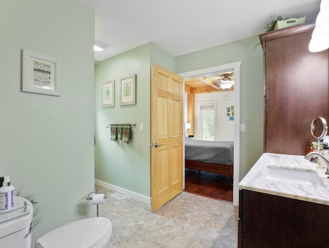 4535 Covered Bridge Rd, Ulster, PA 18850 - bathroom featuring toilet, vanity, baseboards, and a ceiling fan