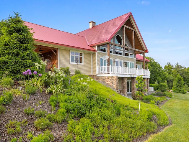 4535 Covered Bridge Rd, Ulster, PA 18850 - back of property featuring a chimney, a balcony, ceiling fan, and metal roof