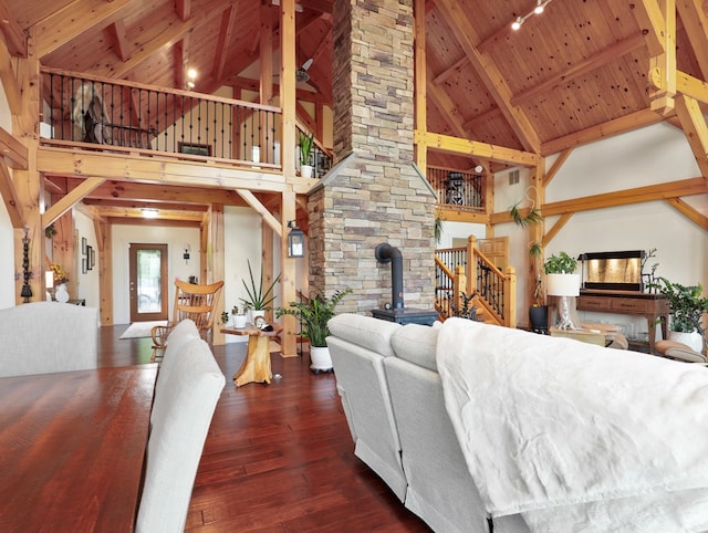 4535 Covered Bridge Rd, Ulster, PA 18850 - living room with high vaulted ceiling, wood ceiling with exposed beams, a wood stove, wood-type flooring, and stairs