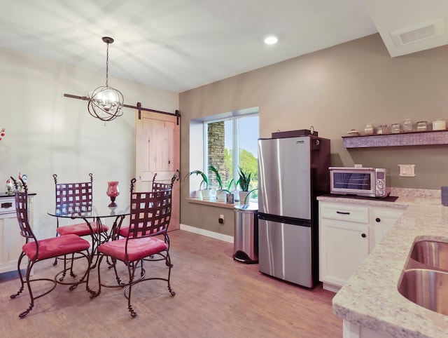 4535 Covered Bridge Rd, Ulster, PA 18850 - dining room with light wood finished floors, a barn door, baseboards, and recessed lighting