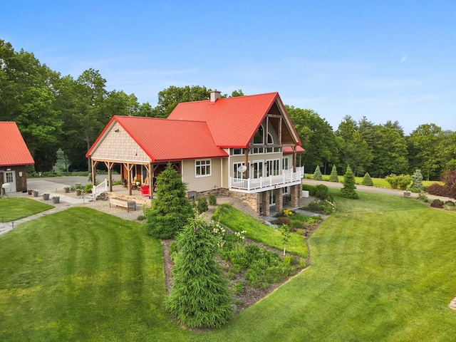 4535 Covered Bridge Rd, Ulster, PA 18850 - view of front of home featuring a front yard, a chimney, a patio area, and metal roof