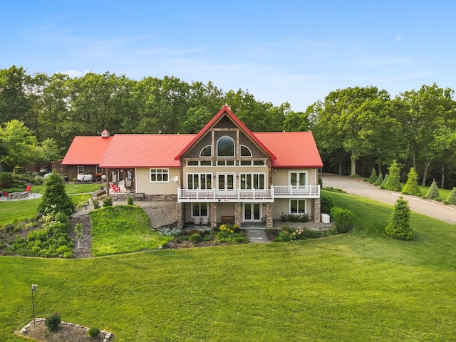 4535 Covered Bridge Rd, Ulster, PA 18850 - rear view of house with a lawn, metal roof, french doors, and a balcony
