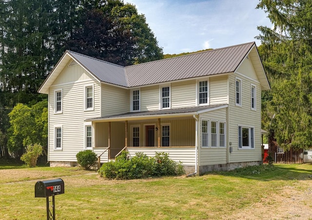 view of front of house with a porch and a front yard