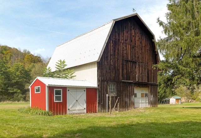 view of outdoor structure featuring a lawn