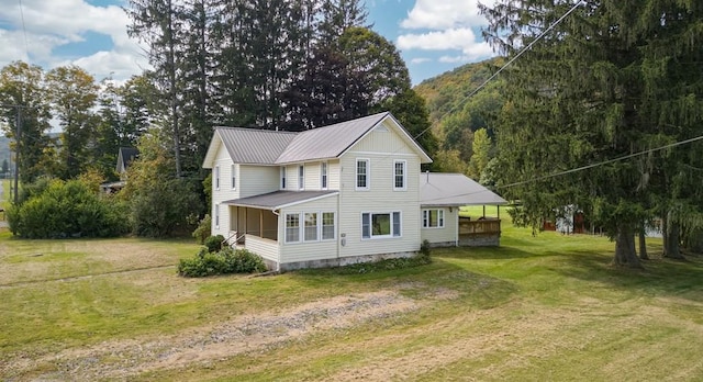 view of property exterior featuring a sunroom and a lawn