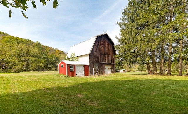 view of outbuilding featuring a lawn