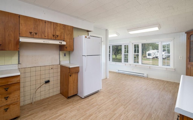 kitchen featuring light hardwood / wood-style floors, a baseboard radiator, and white fridge