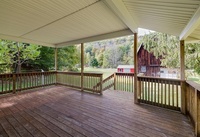 deck featuring a yard and a storage unit