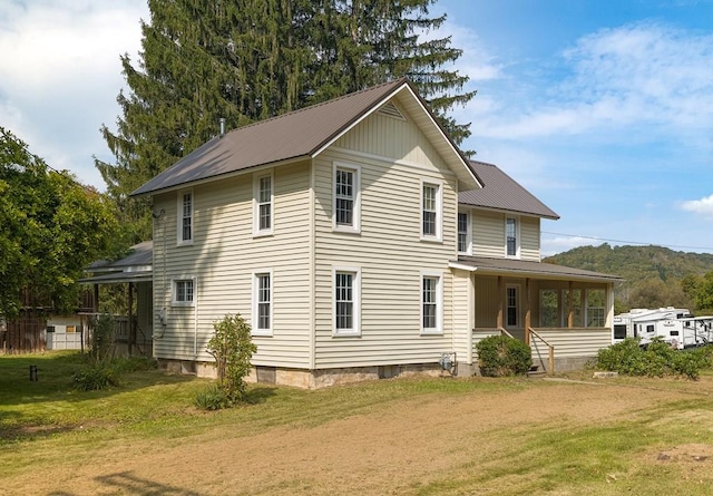 view of property exterior with a porch and a lawn