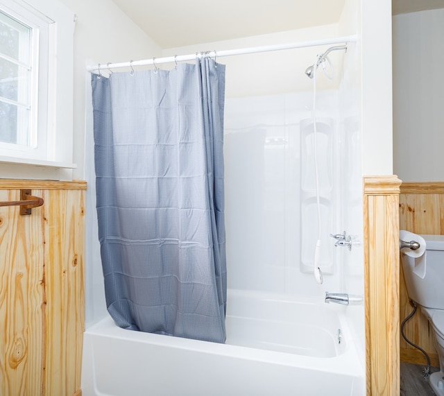 bathroom with shower / tub combo and toilet