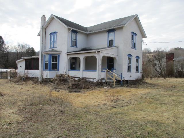 4 Main St, Lockwood, NY 14859 - view of front of home featuring stucco siding, a chimney, and a front yard