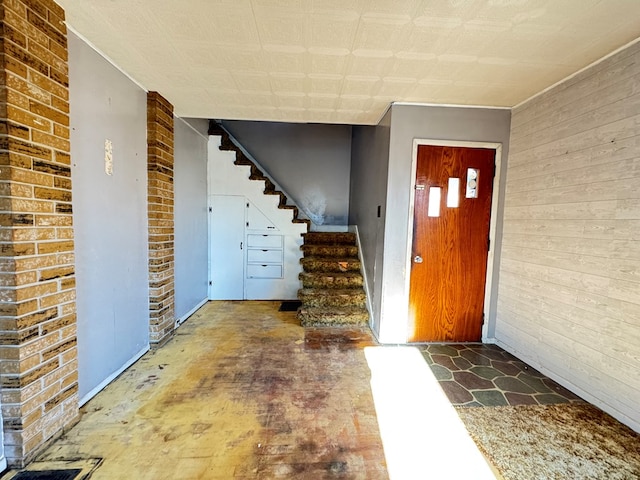 foyer entrance with brick wall