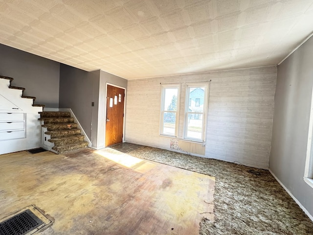 foyer featuring wood walls