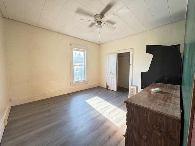 bedroom with ceiling fan and dark wood-type flooring