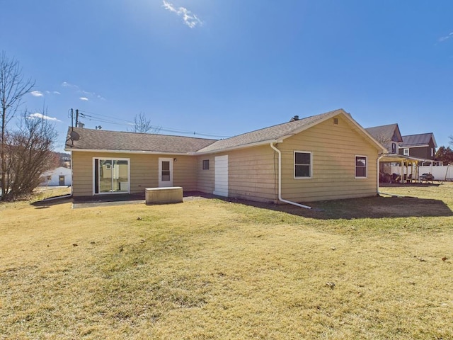 rear view of house featuring a yard