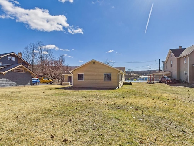 view of side of property featuring a yard