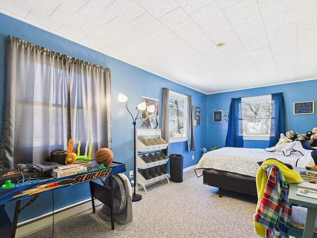 carpeted bedroom with a baseboard heating unit and baseboards