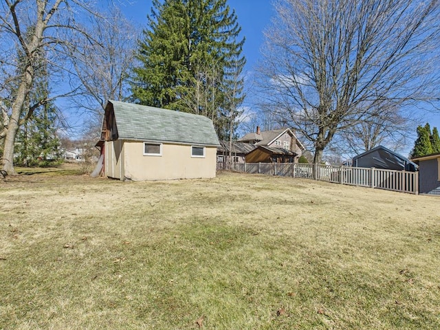 view of yard featuring an outdoor structure and fence